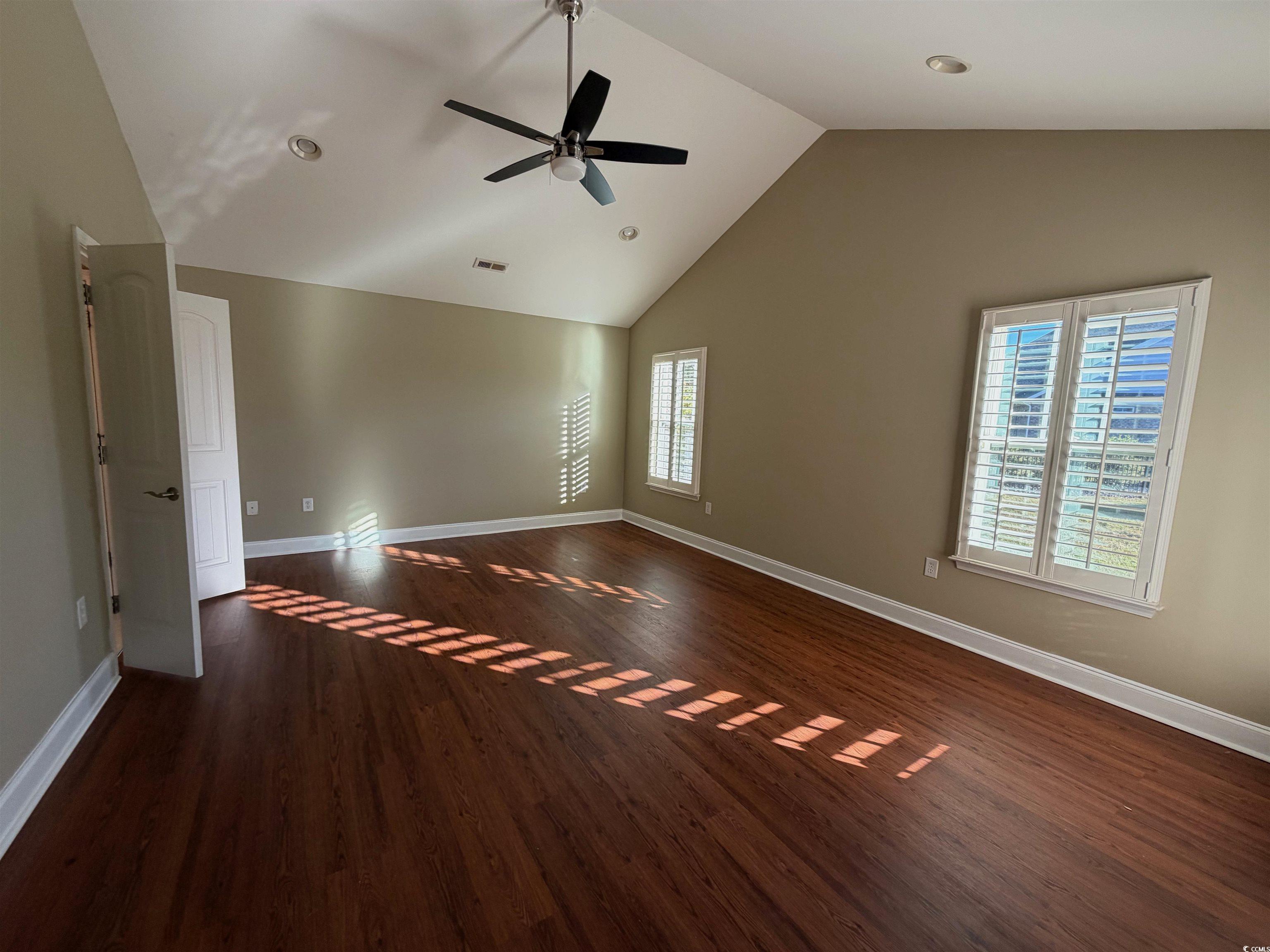 619 Uniola Drive Myrtle Beach, SC 29579 - Photo 10 of 22 Spare room featuring dark wood finished floors, high vaulted ceiling, ceiling fan, and recessed lighting