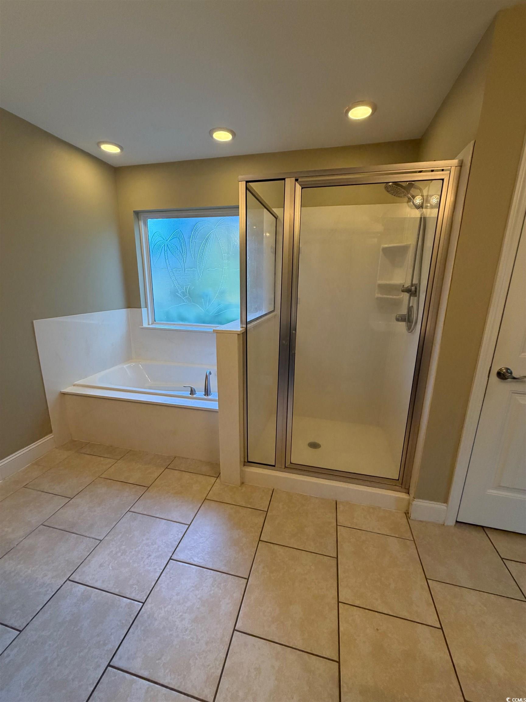 619 Uniola Drive Myrtle Beach, SC 29579 - Photo 13 of 22 Full bath with light tile patterned flooring, a shower stall, recessed lighting, and a bath