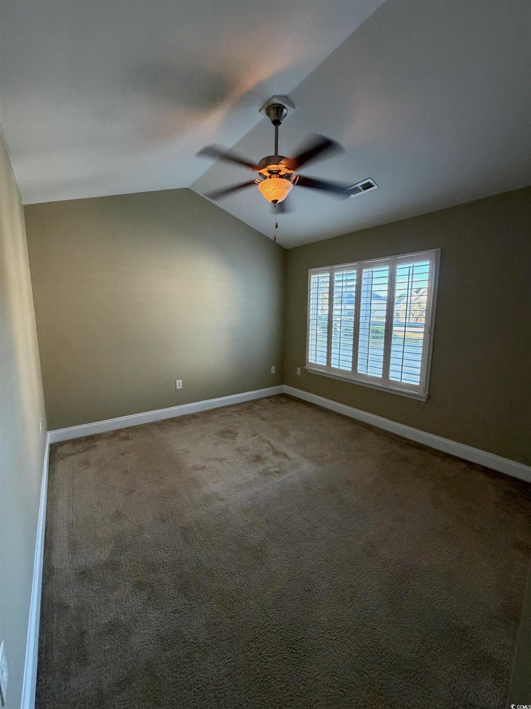 619 Uniola Drive Myrtle Beach, SC 29579 - Photo 14 of 22 Unfurnished room featuring carpet floors, lofted ceiling, and ceiling fan