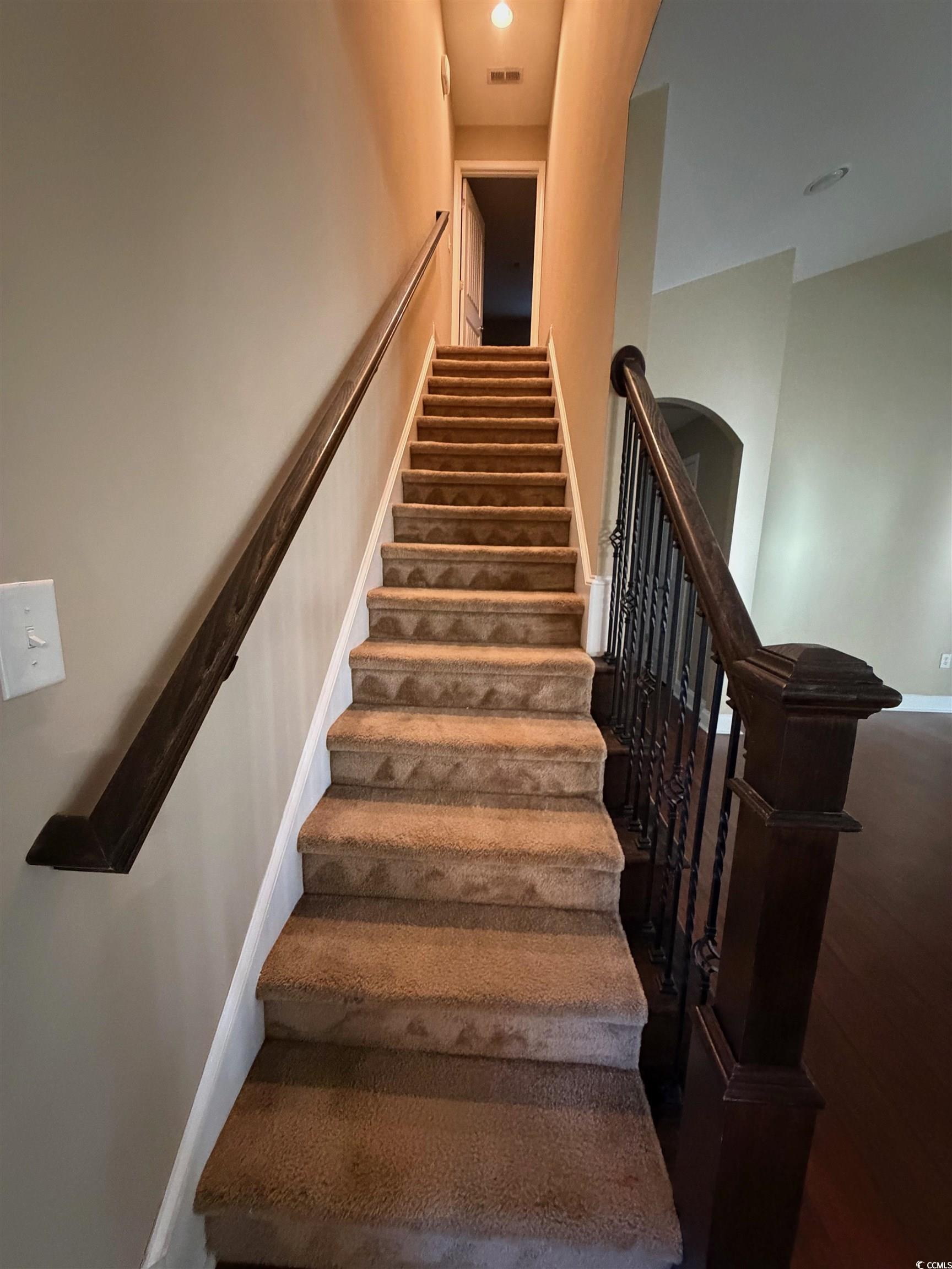 619 Uniola Drive Myrtle Beach, SC 29579 - Photo 18 of 22 Staircase featuring arched walkways and wood finished floors