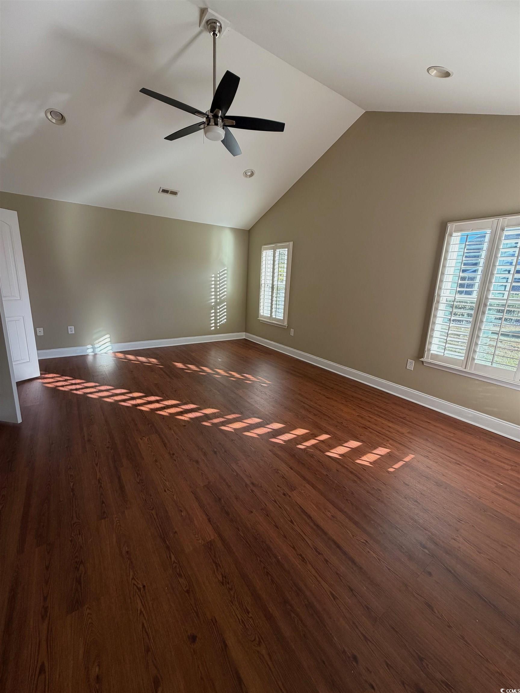 619 Uniola Drive Myrtle Beach, SC 29579 - Photo 9 of 22 Spare room with lofted ceiling, dark wood-style floors, and recessed lighting