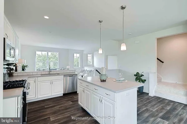a kitchen with center island and white cabinets
