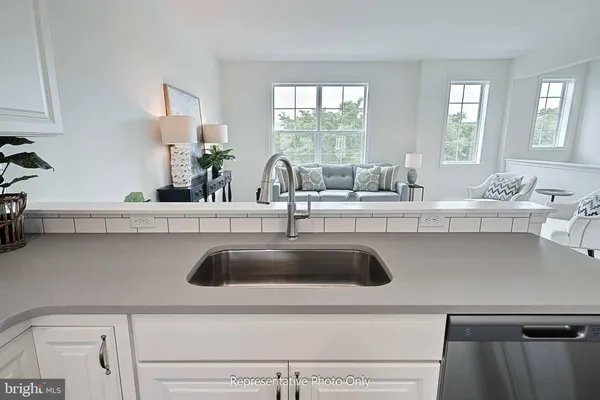 a close view of sink and a vanity with window