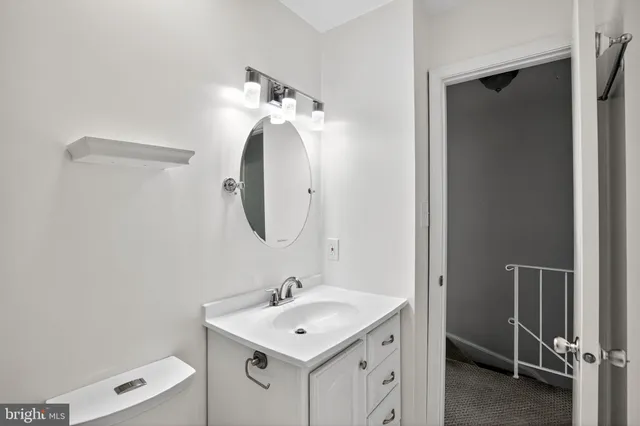 a bathroom with a toilet sink and mirror