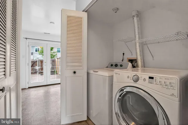 a view of storage and utility room with washer and dryer