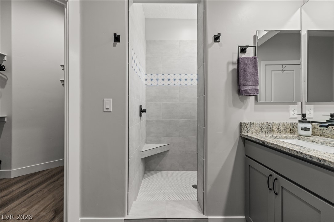 1436 Manassas Ridge Mesquite, NV 89027 - Photo 39 of 77 A sleek, contemporary bathroom features a spacious walk-in shower and elegant dual vanity with granite counters.