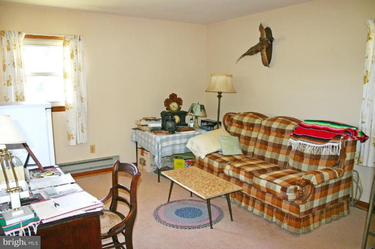 3570 Water Tank Road Manchester, MD 21102 - Photo 5 of 18 a bedroom with a bed and a table in it