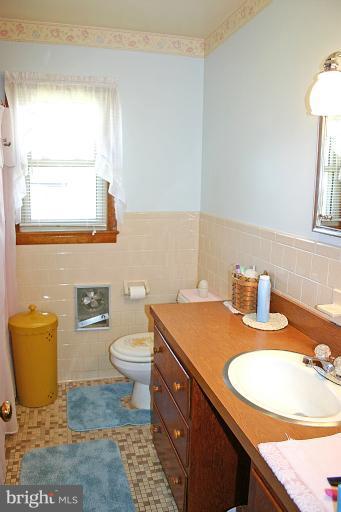 3570 Water Tank Road Manchester, MD 21102 - Photo 8 of 18 a bathroom with a granite countertop sink a toilet and a mirror