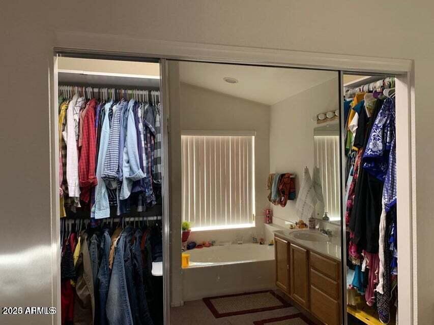 2720 South Los Altos Place Chandler, AZ 85286 - Photo 13 of 20 a view of walk in closet with clothes and shoes