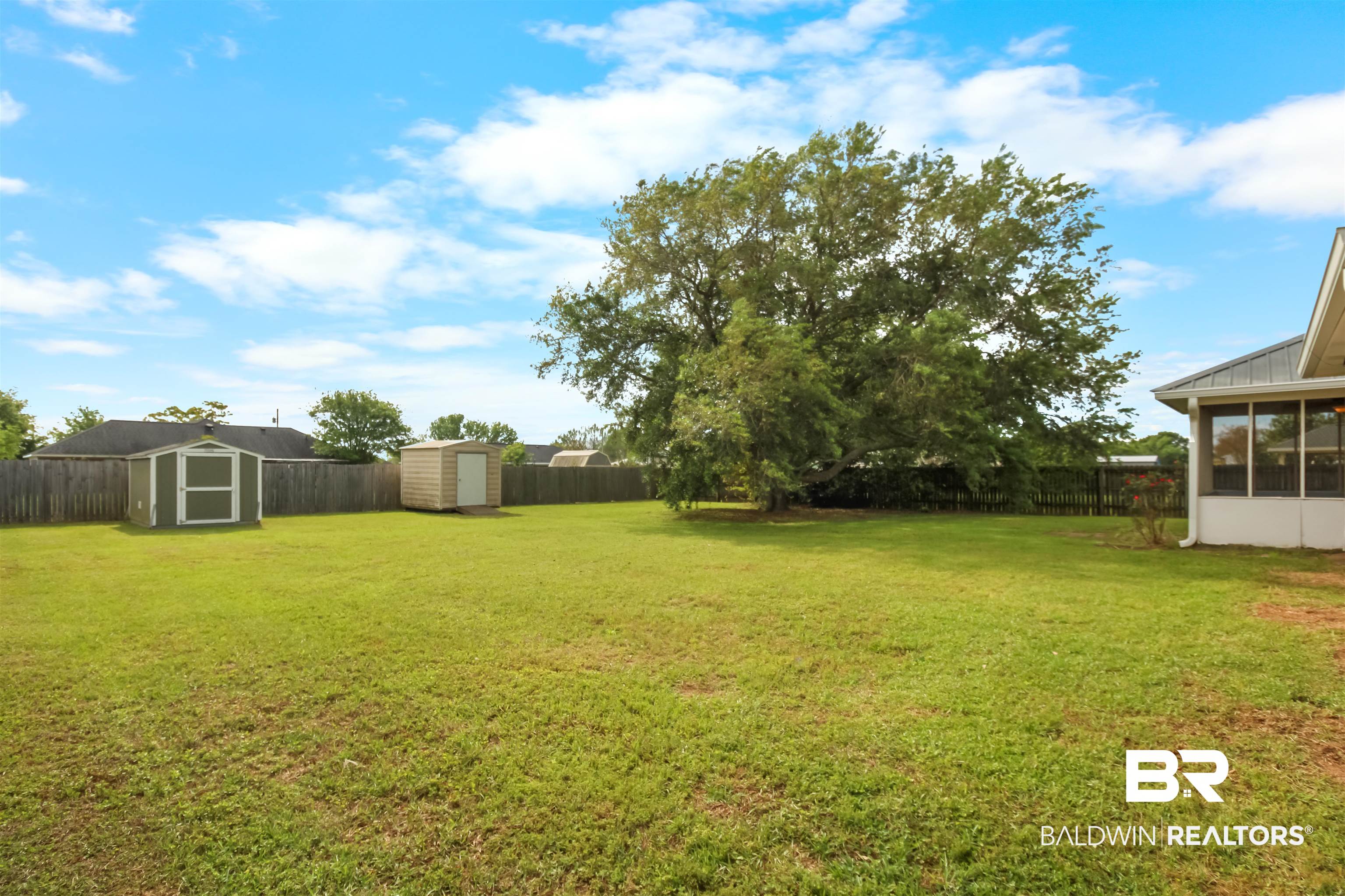 8940 Caitlin Street Foley, AL 36535 - Photo 3 of 27 Fenced backyard featuring a shed and a sunroom