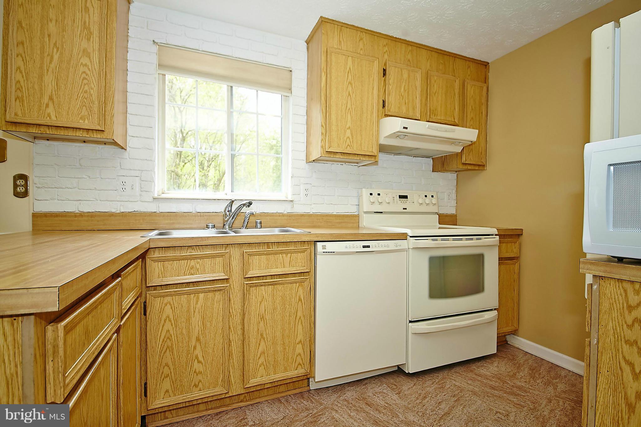 6256 Hillside Road Springfield, VA 22152 - Photo 11 of 30 a kitchen with a sink cabinets and window