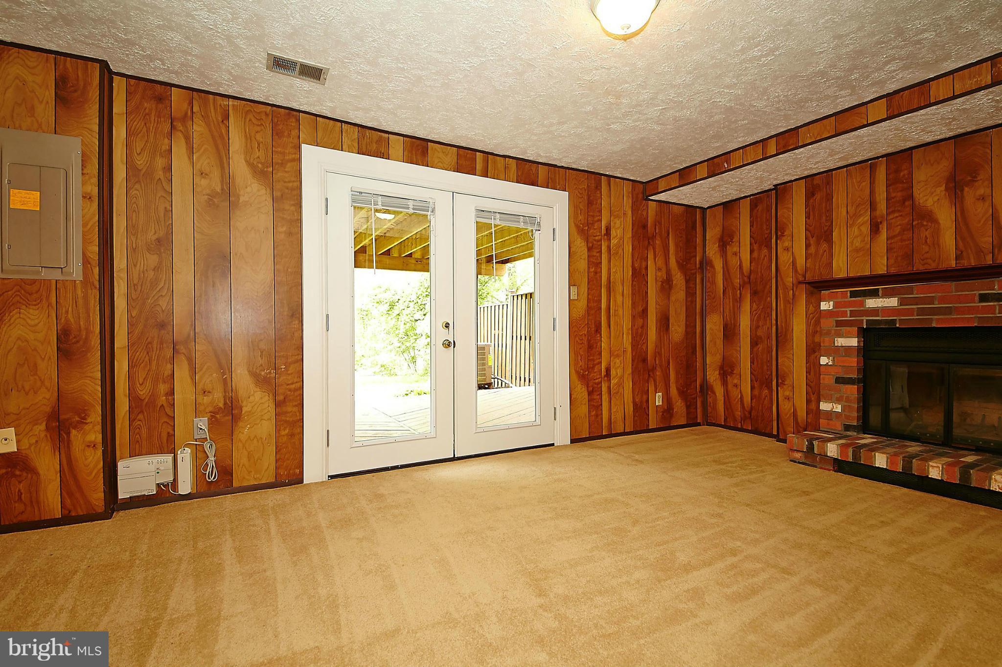 6256 Hillside Road Springfield, VA 22152 - Photo 22 of 30 a view of an empty room with a fireplace and a window