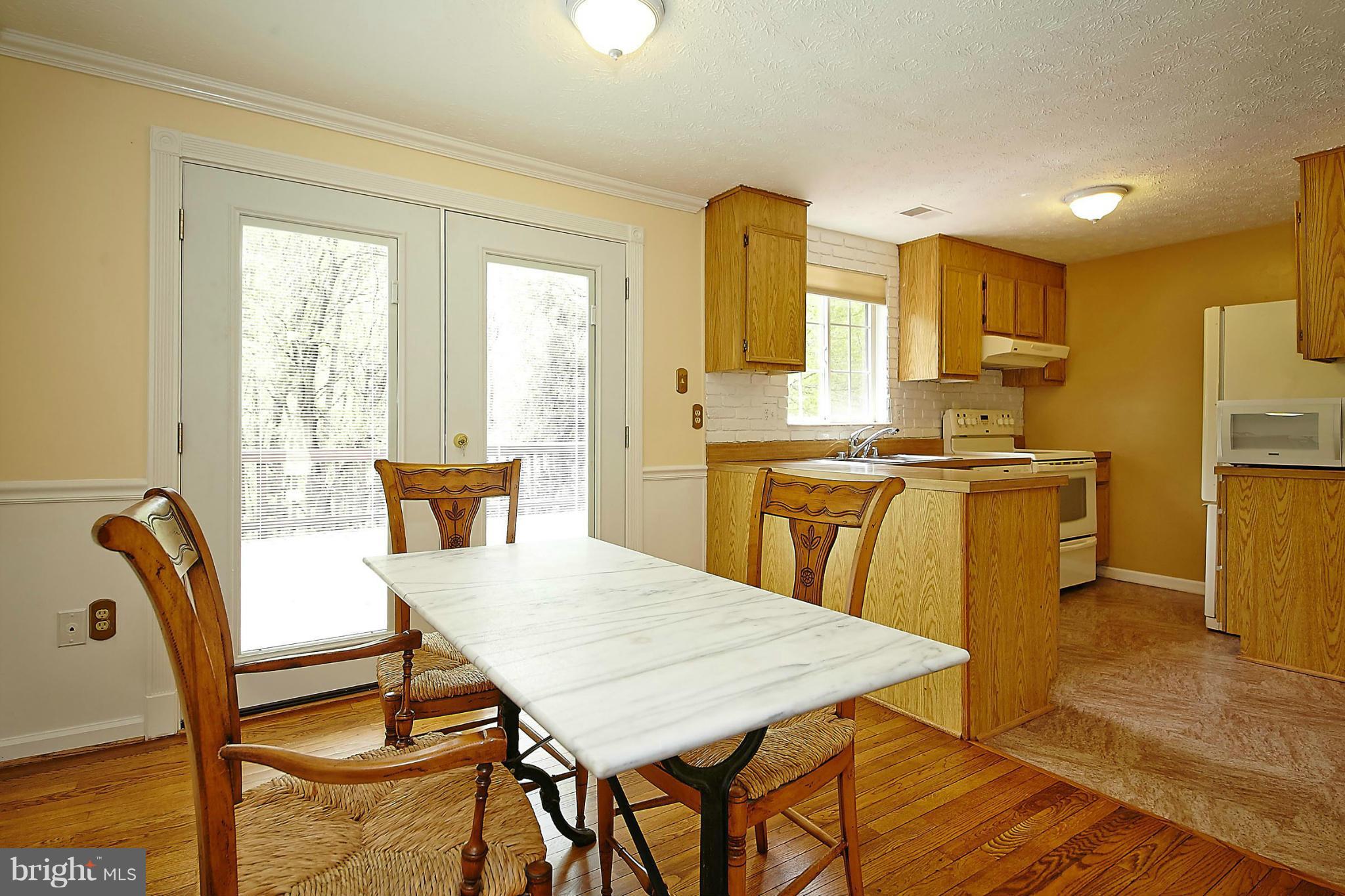 6256 Hillside Road Springfield, VA 22152 - Photo 9 of 30 a view of a dining room with furniture and a window