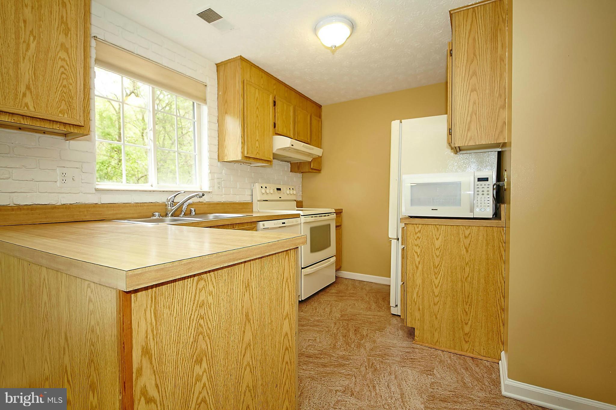 6256 Hillside Road Springfield, VA 22152 - Photo 10 of 30 a kitchen with a sink and a refrigerator