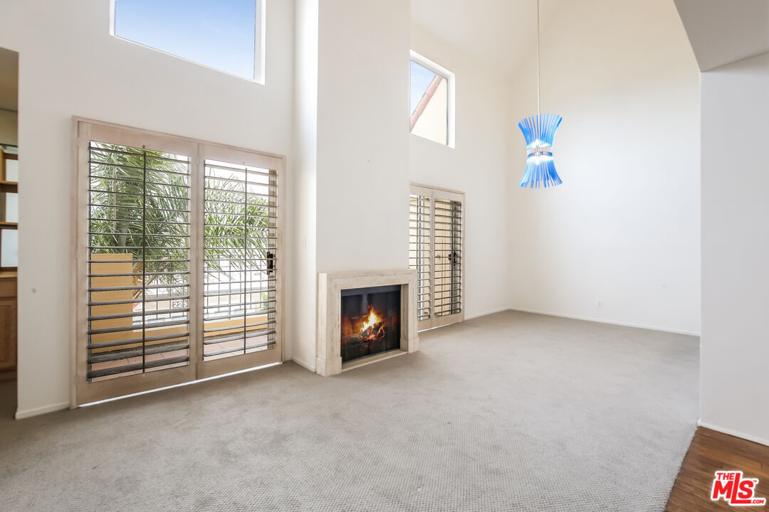 a view of a livingroom with an empty space and a fireplace