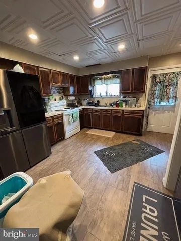 a kitchen with stainless steel appliances granite countertop a sink a stove a microwave a counter top and cabinets