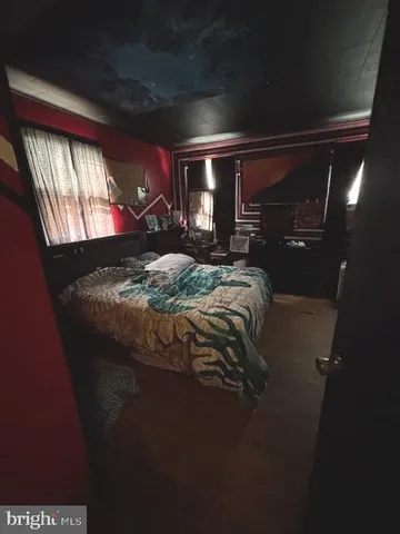 a bed sitting in a room next to a window
