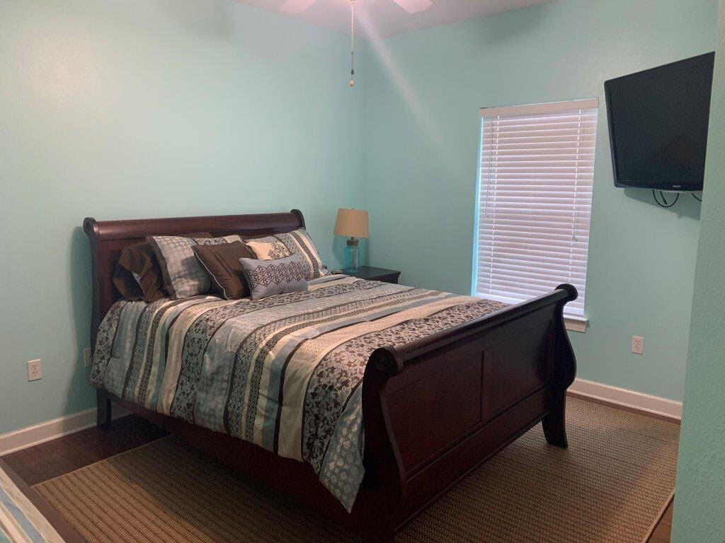 54 Batchelors Button Drive, Unit 9 Miramar Beach, FL 32550 - Photo 27 of 28 a bedroom with a bed and a flat screen tv