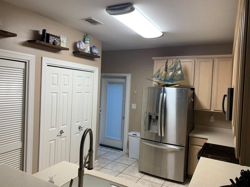 54 Batchelors Button Drive, Unit 9 Miramar Beach, FL 32550 - Photo 6 of 28 a kitchen with stainless steel appliances granite countertop a refrigerator and a sink
