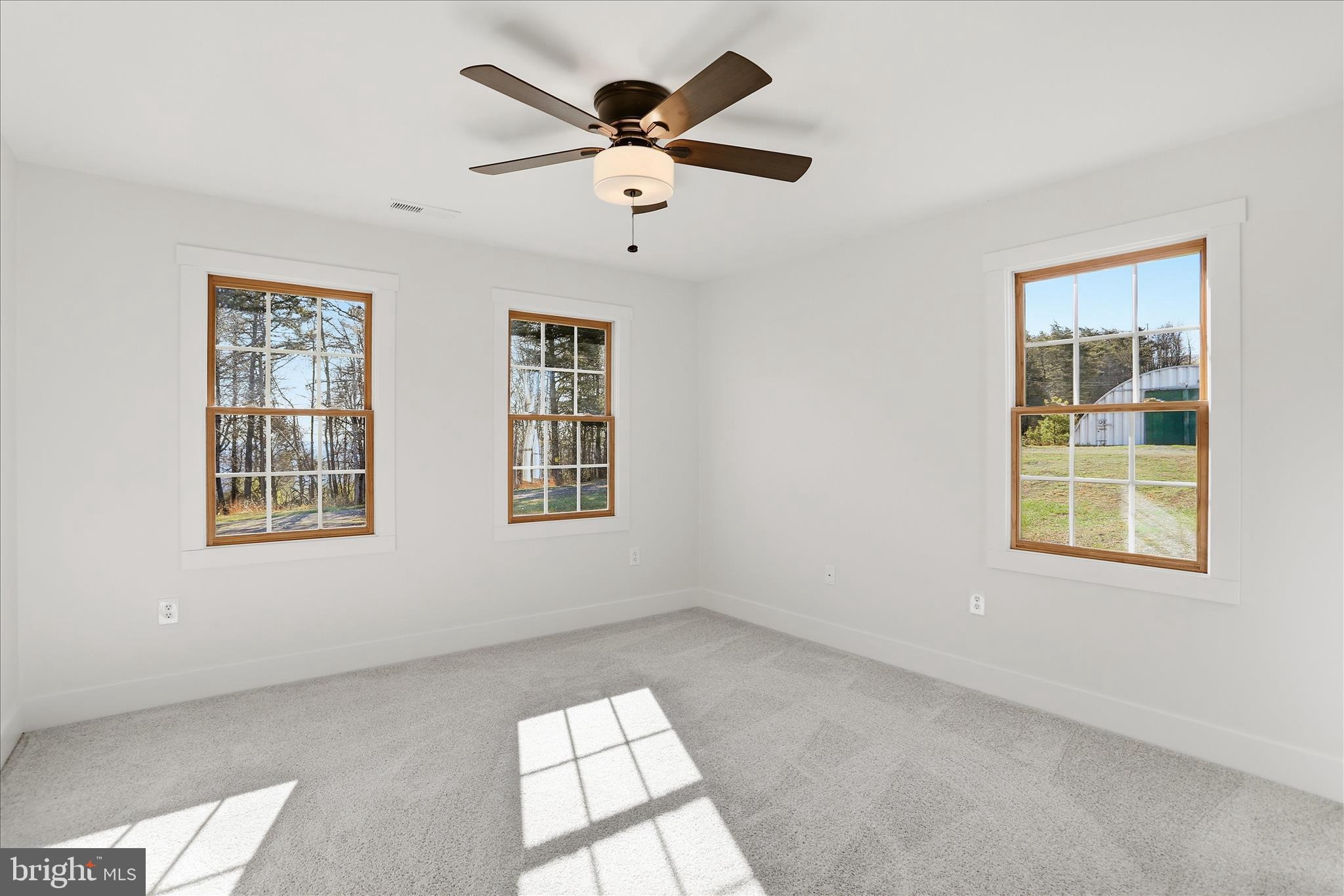 604 Locksa Road Romney, WV 26757 - Photo 16 of 48 an empty room with windows and ceiling fan
