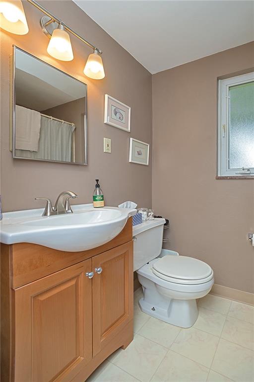 907 Hamil Road Verona, PA 15147 - Photo 11 of 21 a bathroom with a toilet sink and mirror