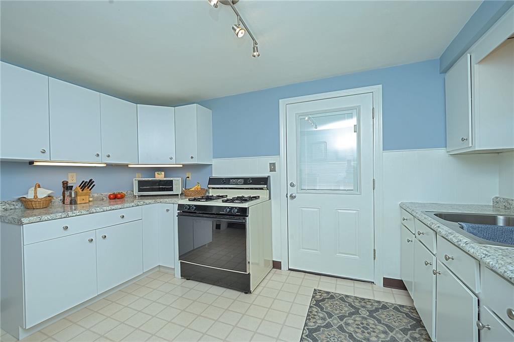 907 Hamil Road Verona, PA 15147 - Photo 12 of 21 a kitchen with stainless steel appliances granite countertop a refrigerator and sink