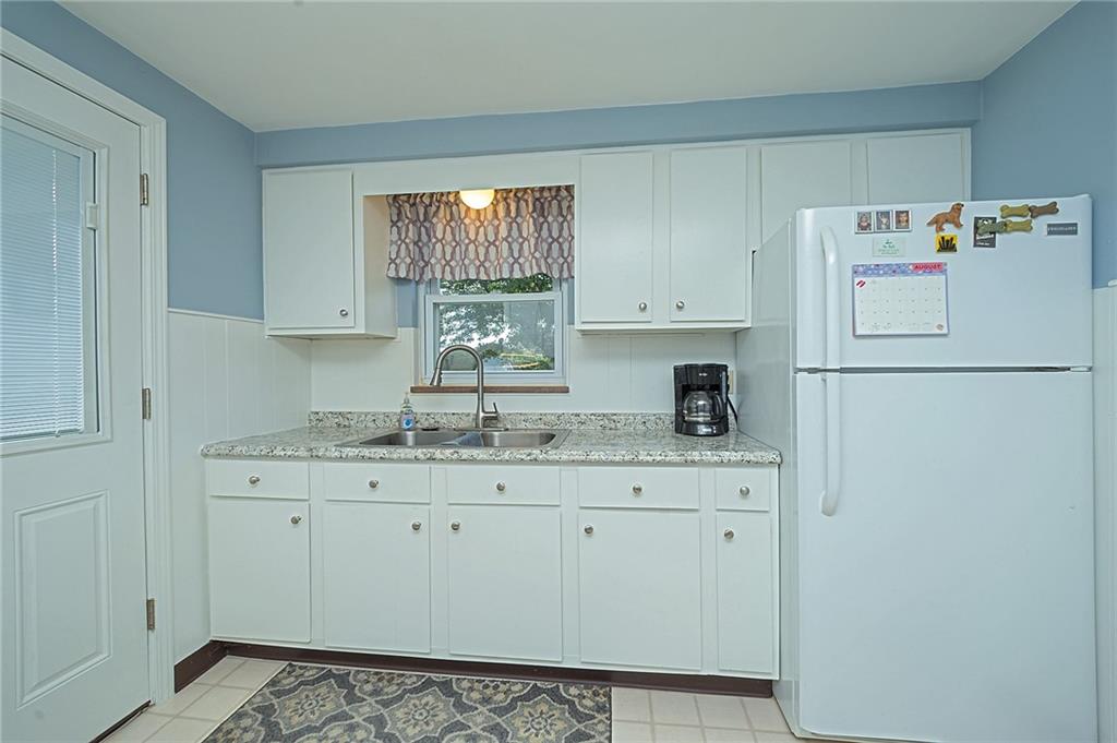 907 Hamil Road Verona, PA 15147 - Photo 14 of 21 a kitchen with a sink a refrigerator and window
