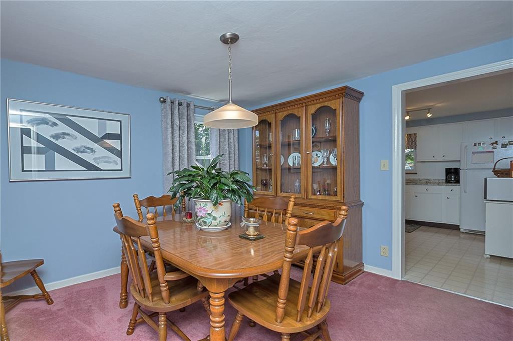 907 Hamil Road Verona, PA 15147 - Photo 17 of 21 a view of a dining room with furniture window and wooden floor