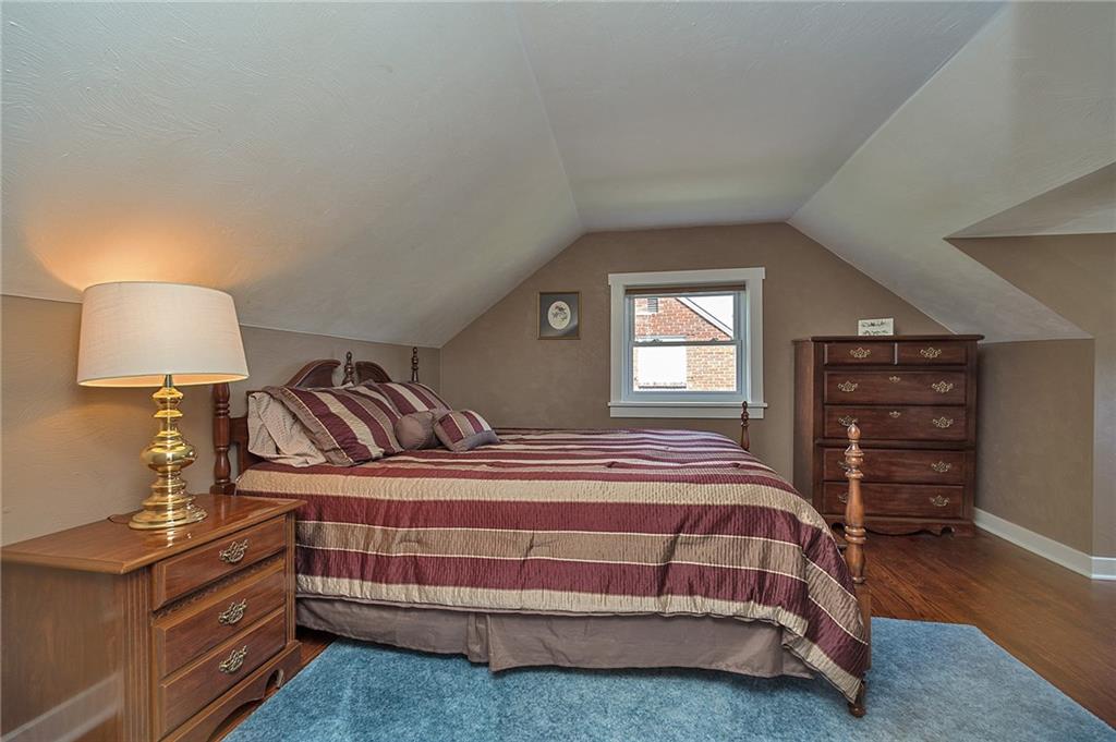 907 Hamil Road Verona, PA 15147 - Photo 18 of 21 a bedroom with a bed and a lamp on dresser