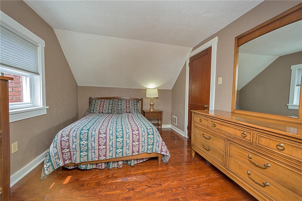 907 Hamil Road Verona, PA 15147 - Photo 20 of 21 a bed sitting in a bedroom next to a window