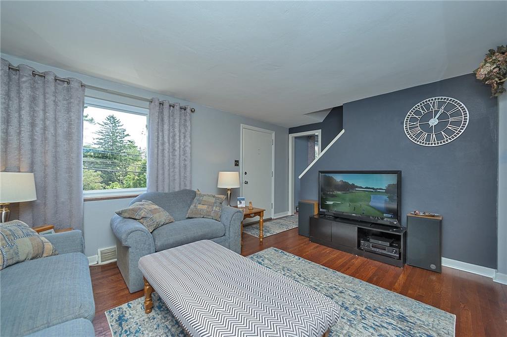 907 Hamil Road Verona, PA 15147 - Photo 8 of 21 a living room with furniture and a flat screen tv