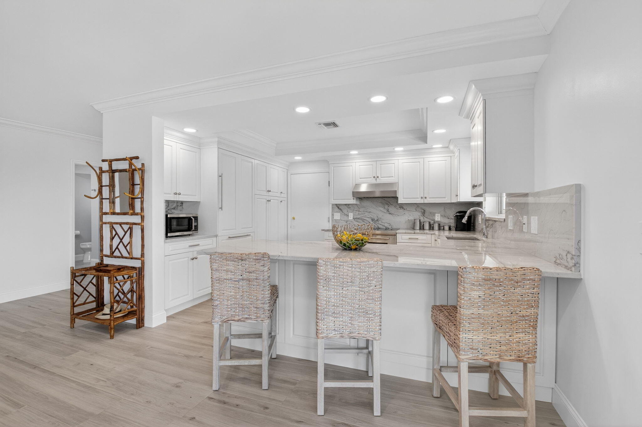 1710 South Ocean Boulevard, Unit 32 Delray Beach, FL 33483 - Photo 13 of 58 a kitchen with stainless steel appliances kitchen island granite countertop a table chairs sink and cabinets