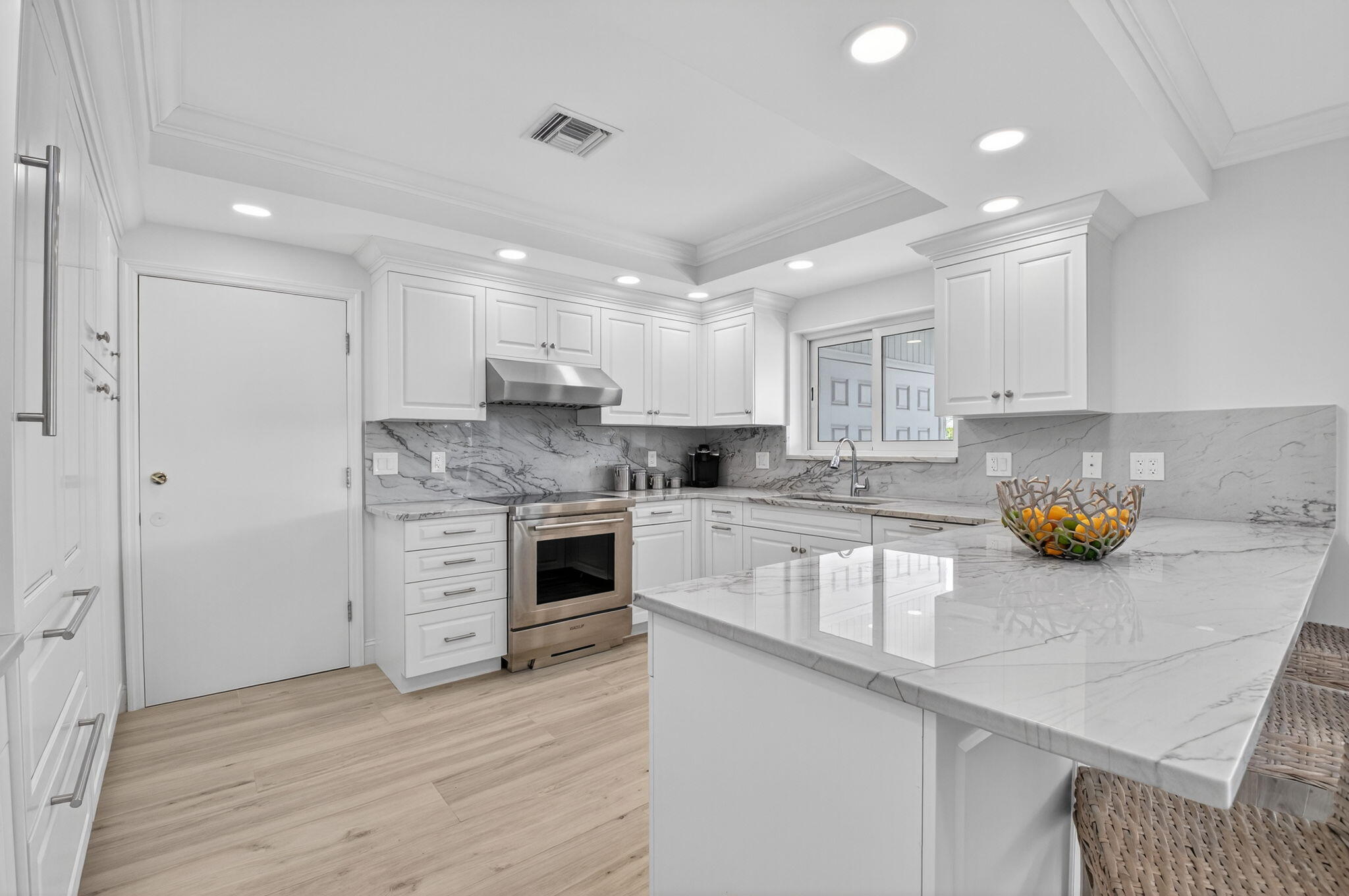 1710 South Ocean Boulevard, Unit 32 Delray Beach, FL 33483 - Photo 15 of 58 a kitchen with a sink stainless steel appliances and cabinets