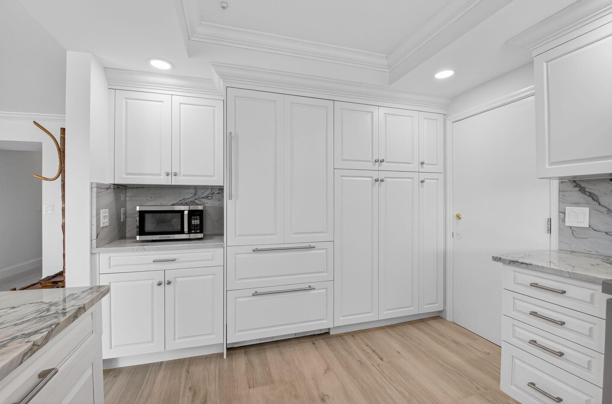 1710 South Ocean Boulevard, Unit 32 Delray Beach, FL 33483 - Photo 16 of 58 a view of a kitchen with white cabinets stainless steel appliances and wooden floor