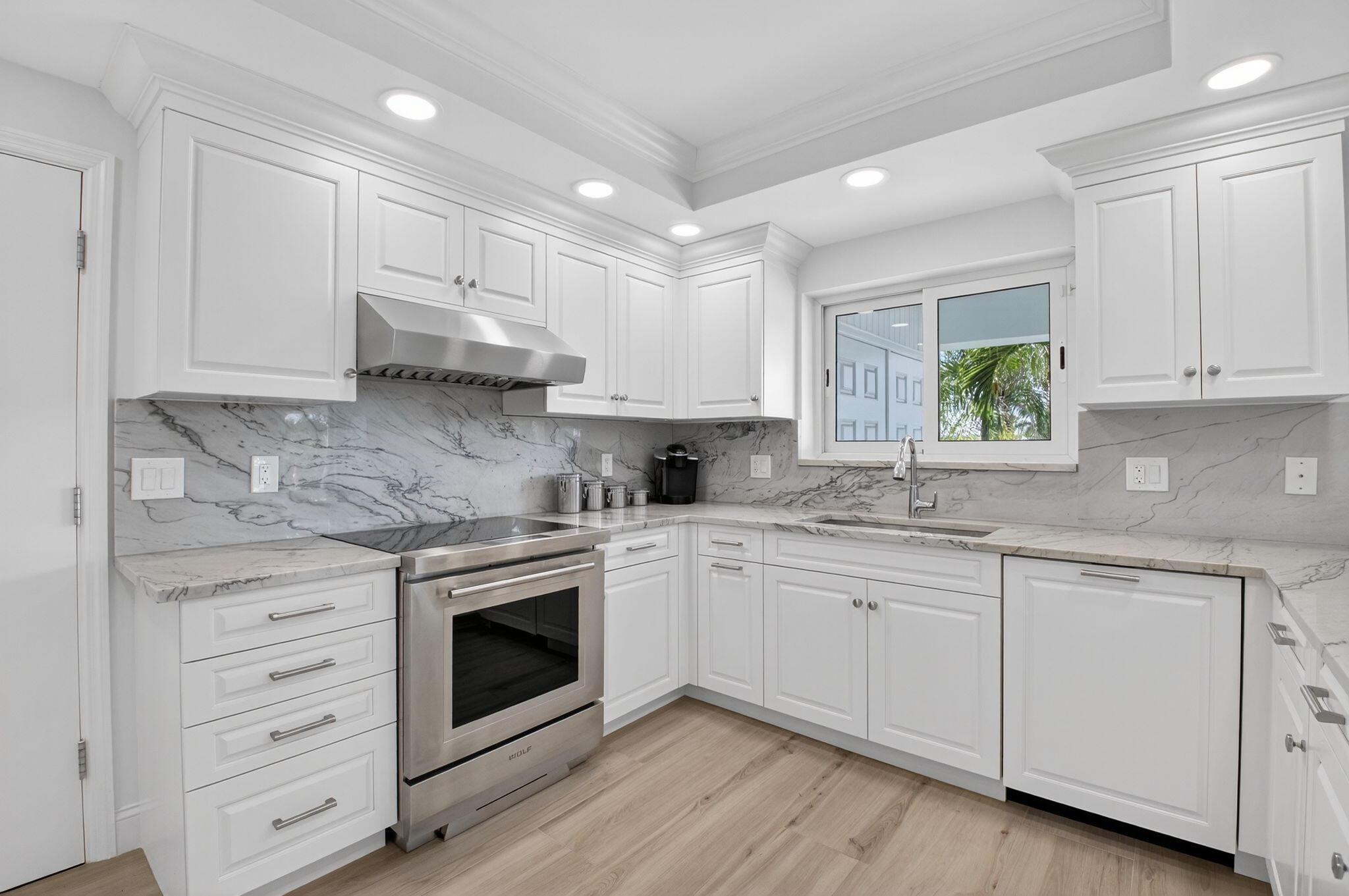 1710 South Ocean Boulevard, Unit 32 Delray Beach, FL 33483 - Photo 17 of 58 a kitchen with granite countertop white cabinets and white appliances