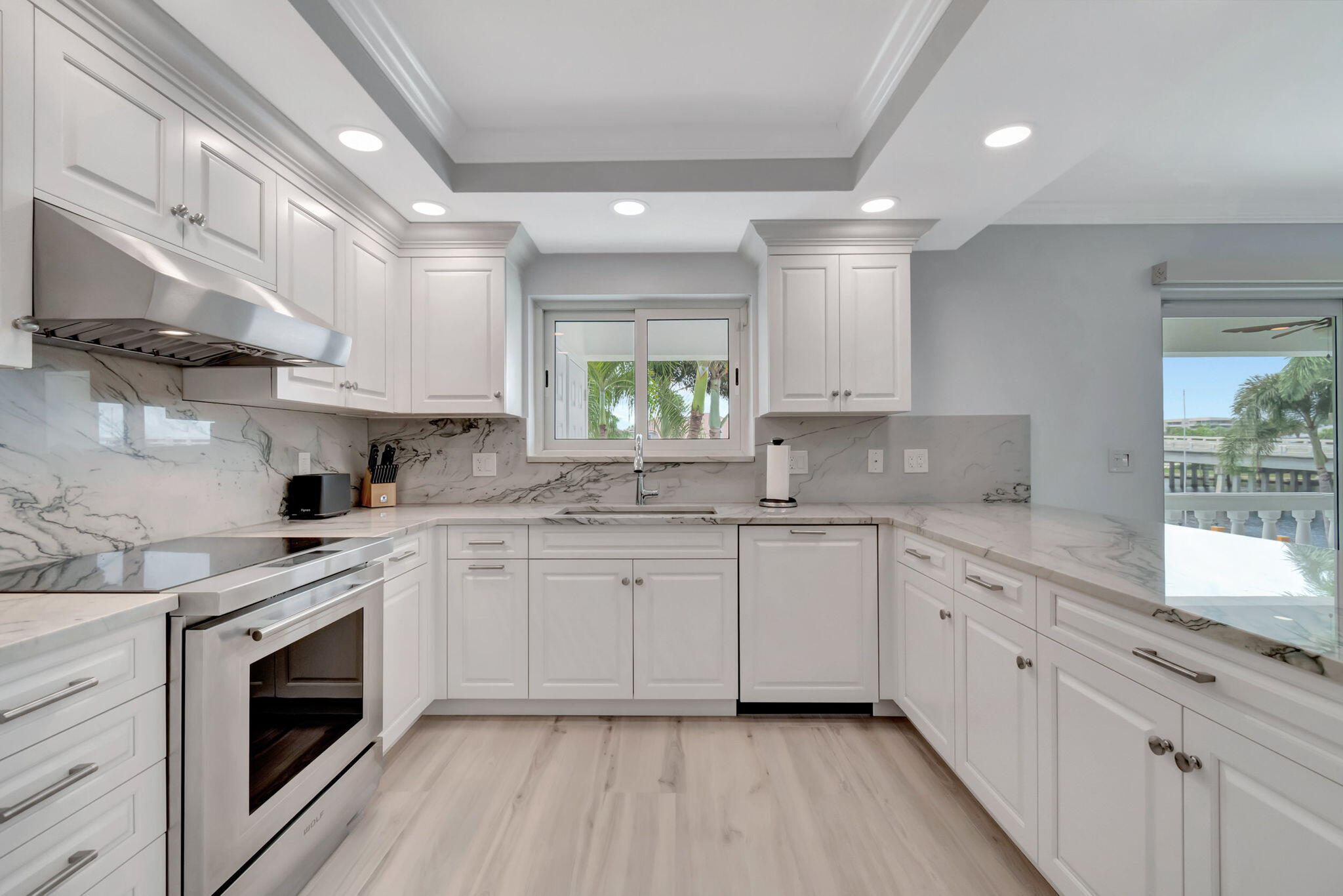 1710 South Ocean Boulevard, Unit 32 Delray Beach, FL 33483 - Photo 18 of 58 a kitchen with granite countertop white cabinets and white appliances