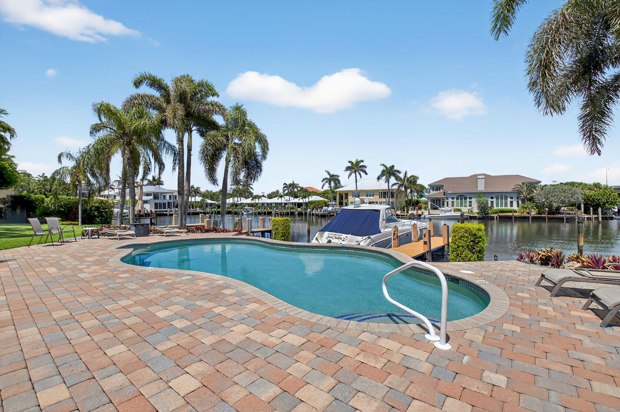 1710 South Ocean Boulevard, Unit 32 Delray Beach, FL 33483 - Photo 36 of 58 a view of a swimming pool and lounge chairs