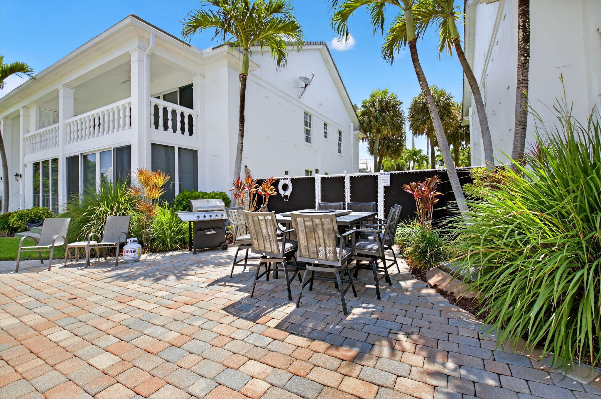 1710 South Ocean Boulevard, Unit 32 Delray Beach, FL 33483 - Photo 42 of 58 a view of a patio with table and chairs and potted plants