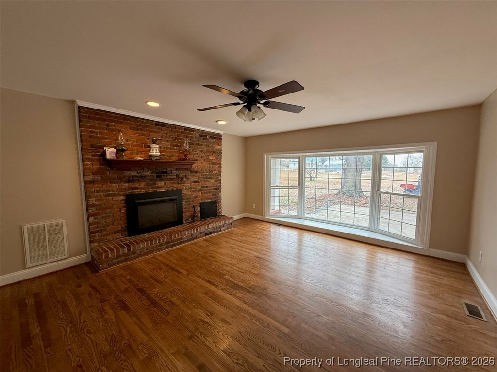 161 Fowler Lane Dunn, NC 28334 - Photo 2 of 12 a view of an empty room with a fireplace and a window