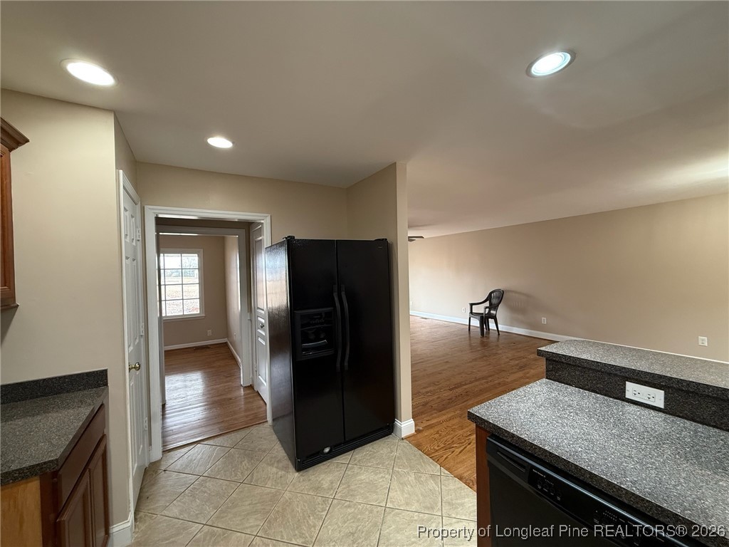 161 Fowler Lane Dunn, NC 28334 - Photo 3 of 12 a kitchen with a refrigerator and a sink