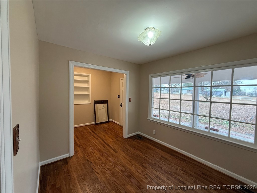 161 Fowler Lane Dunn, NC 28334 - Photo 5 of 12 wooden floor in an empty room with a window