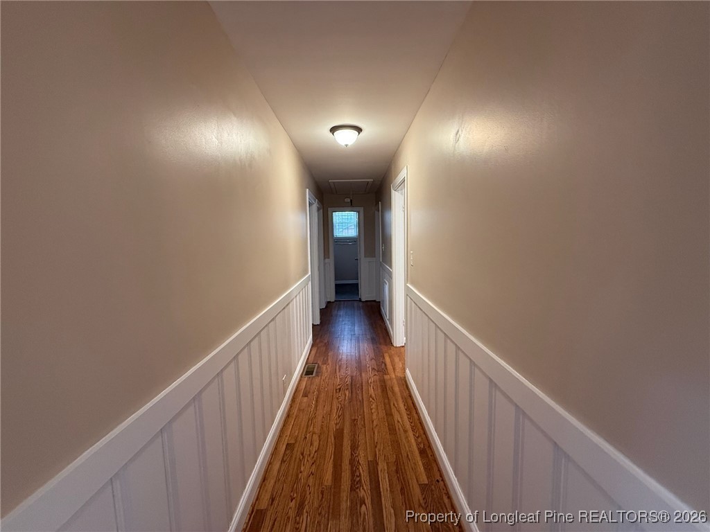 161 Fowler Lane Dunn, NC 28334 - Photo 7 of 12 a view of a hallway with wooden floor