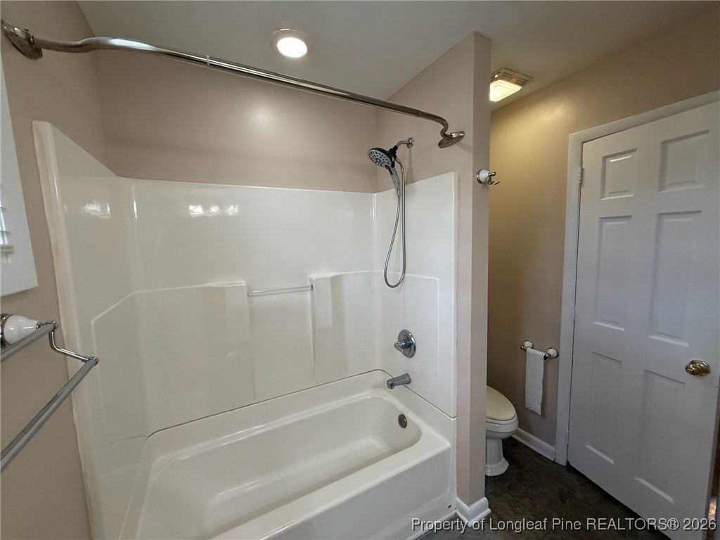 161 Fowler Lane Dunn, NC 28334 - Photo 10 of 12 a bathroom with a bathtub a toilet and a shower