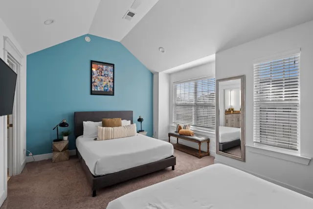 a bedroom with a bed and a large window