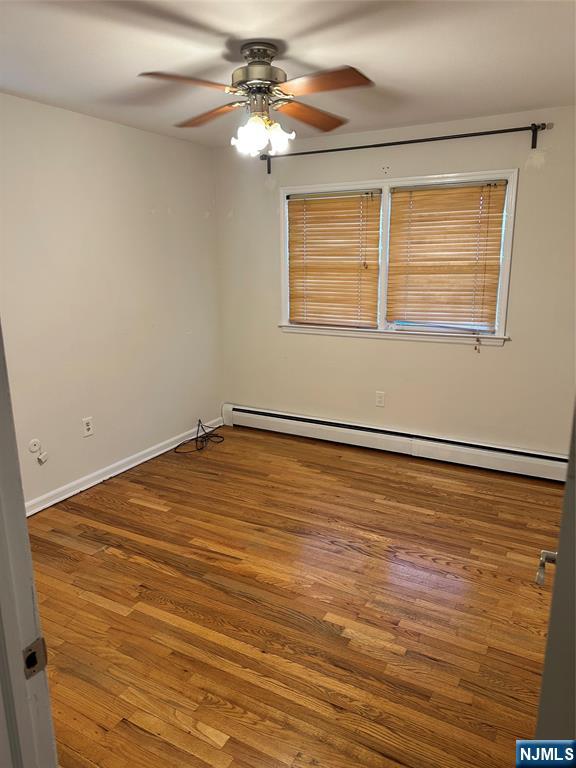 718 Spring Avenue Ridgewood, NJ 07450 - Photo 12 of 20 a view of a room with wooden floor and a ceiling fan