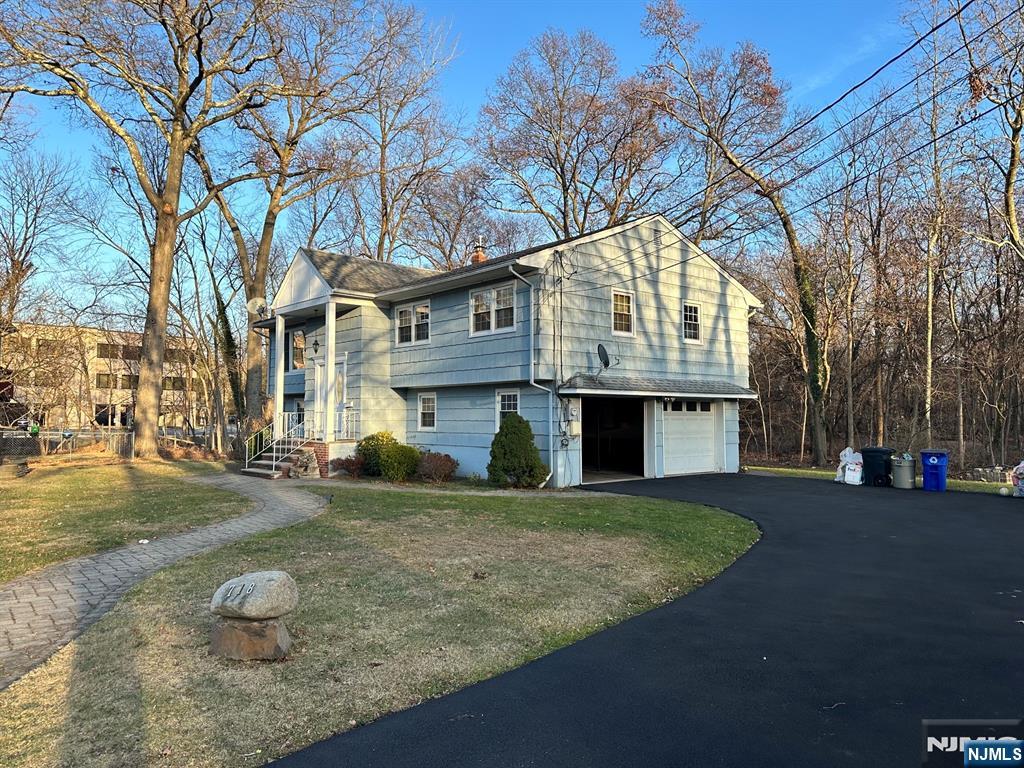 718 Spring Avenue Ridgewood, NJ 07450 - Photo 2 of 20 a front view of a building with a yard