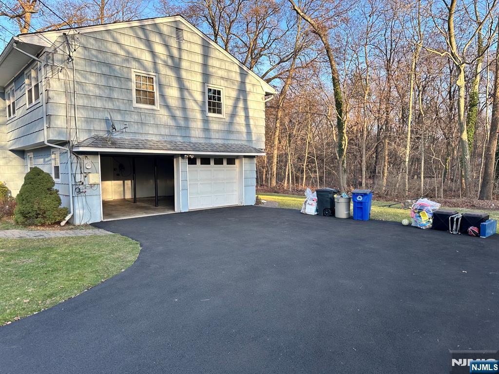 718 Spring Avenue Ridgewood, NJ 07450 - Photo 3 of 20 a front view of a house with a yard