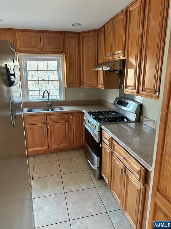 718 Spring Avenue Ridgewood, NJ 07450 - Photo 6 of 20 a kitchen with stainless steel appliances granite countertop a stove a sink and a microwave