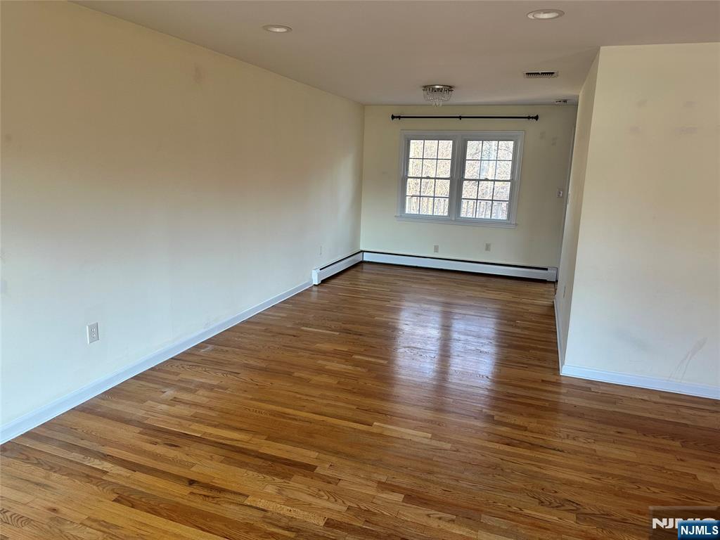 718 Spring Avenue Ridgewood, NJ 07450 - Photo 8 of 20 a view of a room with wooden floor and window