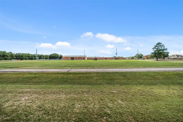 a view of a field with a big yard